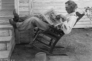 Farmer reading his farm paper